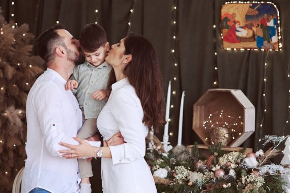 A family celebrates Christmas together, sharing love with holiday decorations.